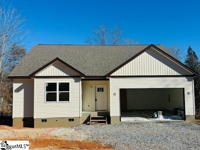 view of front of house with crawl space, driveway, an attached garage, and a shingled roof