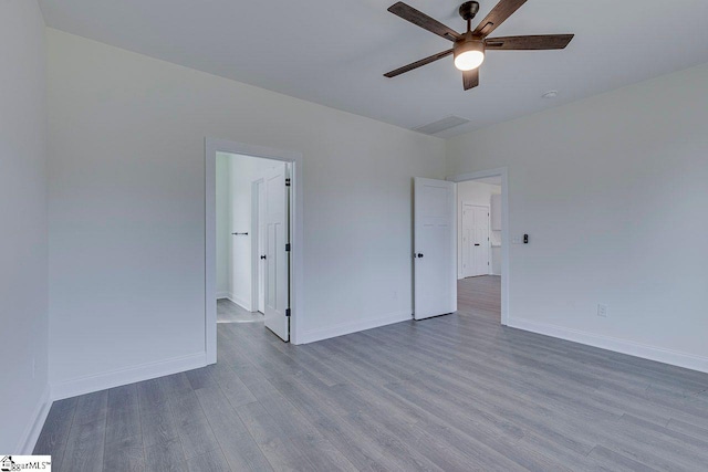 unfurnished bedroom with a ceiling fan, baseboards, and wood finished floors