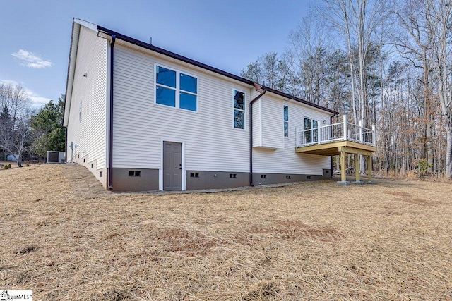 view of side of home featuring cooling unit and crawl space