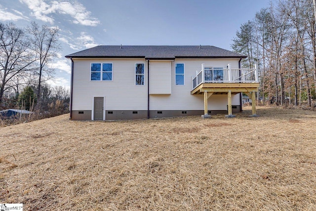 rear view of house featuring a shingled roof, crawl space, and a wooden deck