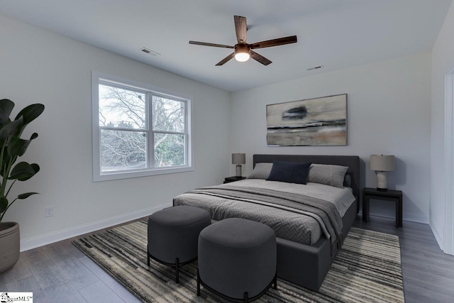 bedroom featuring visible vents, baseboards, and wood finished floors