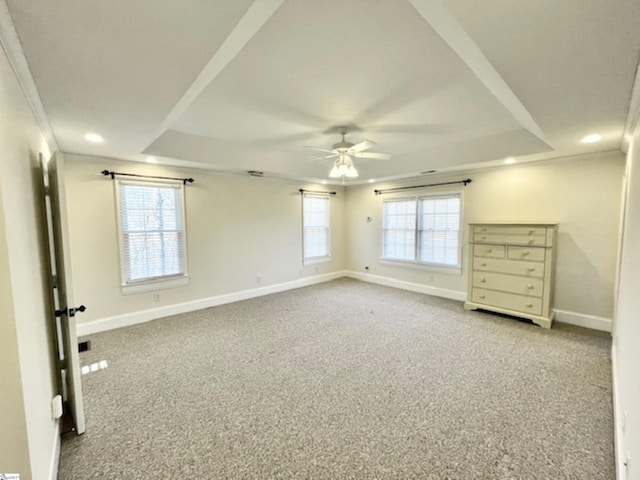 unfurnished bedroom with ceiling fan, light colored carpet, crown molding, and multiple windows