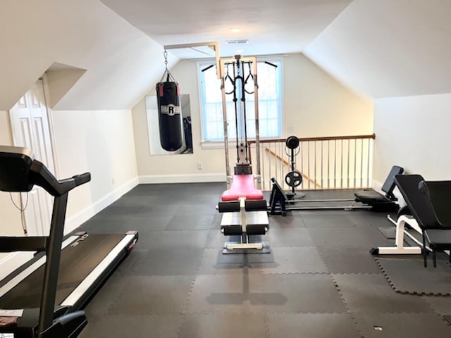 exercise room featuring vaulted ceiling