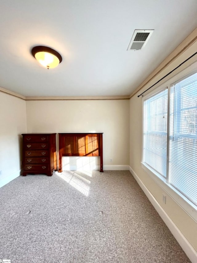 empty room with carpet floors and ornamental molding