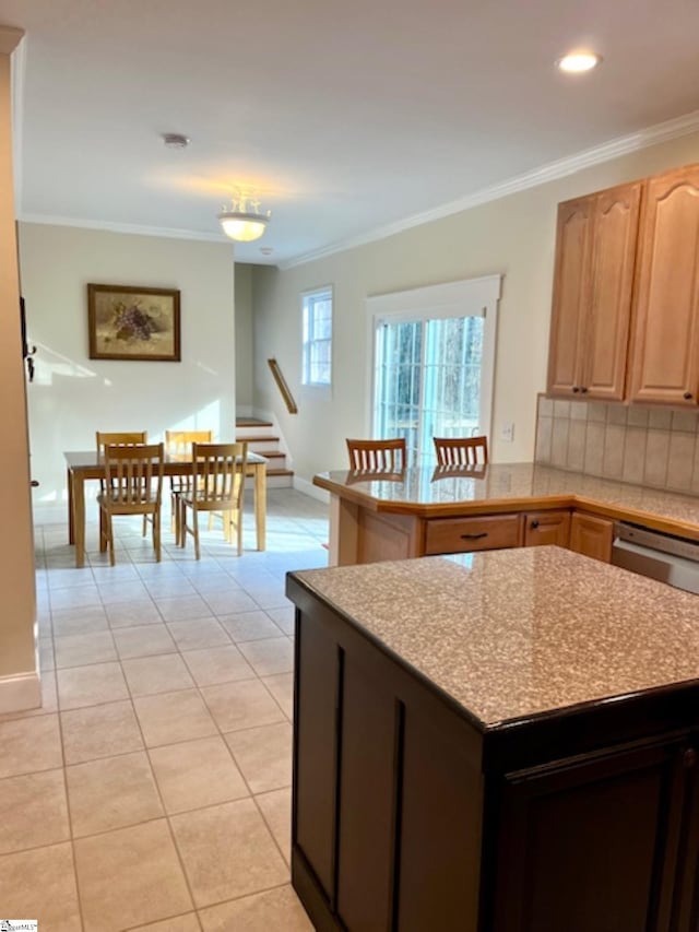 kitchen with dishwasher, light tile patterned floors, tasteful backsplash, and crown molding