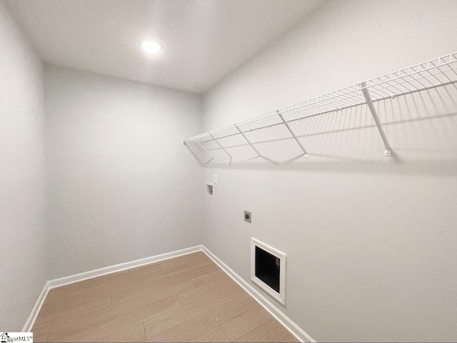 508 Pennystone Ln, Simpsonville, SC 29681 - washroom with light wood-type flooring, hookup for a washing machine, baseboards, electric dryer hookup, and laundry area