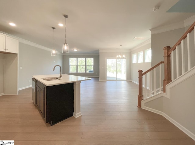 508 Pennystone Ln, Simpsonville, SC 29681 - kitchen with crown molding, light countertops, a sink, a chandelier, and light wood-type flooring