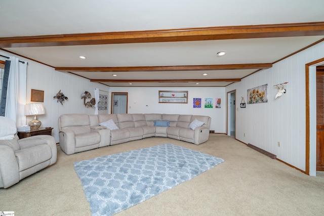 living room with beamed ceiling and light colored carpet