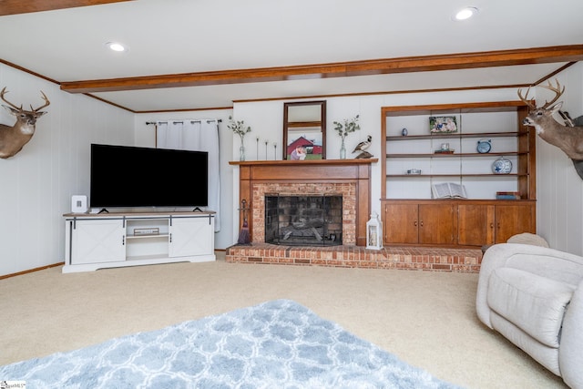 carpeted living room with beam ceiling and a brick fireplace