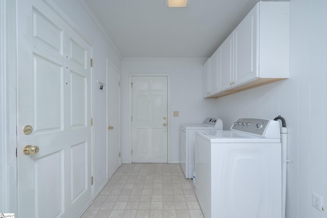 laundry area featuring cabinets, separate washer and dryer, and crown molding