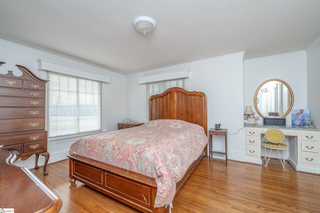 bedroom with light hardwood / wood-style floors and ornamental molding