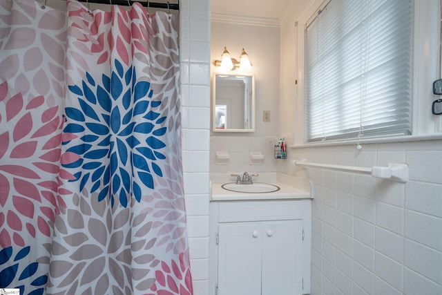 bathroom featuring a shower with shower curtain, vanity, tile walls, and ornamental molding