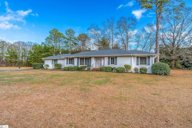 ranch-style home with a front lawn