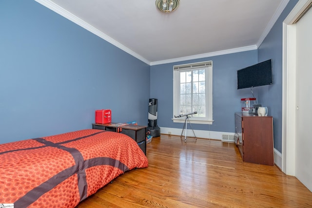 bedroom featuring wood-type flooring and ornamental molding