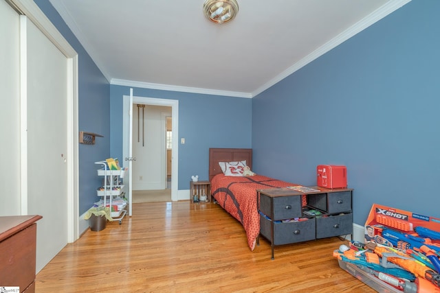 bedroom featuring light wood-type flooring and crown molding