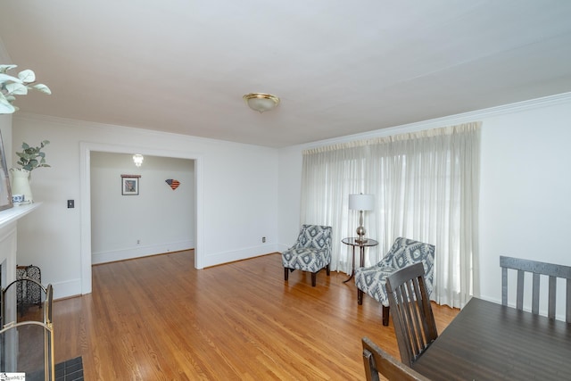 sitting room featuring hardwood / wood-style flooring and ornamental molding