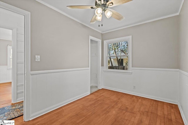 unfurnished room with crown molding, hardwood / wood-style floors, and ceiling fan