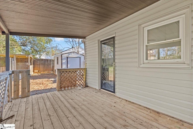 wooden deck featuring a storage shed