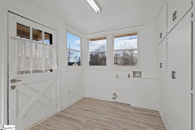 washroom with washer hookup, light hardwood / wood-style flooring, and electric dryer hookup