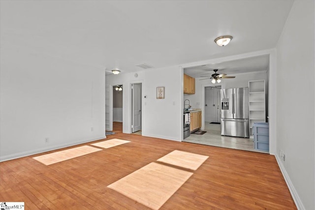 unfurnished living room with light hardwood / wood-style flooring and ceiling fan