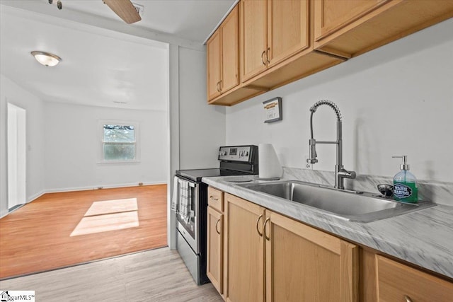 kitchen featuring ceiling fan, sink, light hardwood / wood-style floors, and stainless steel range with electric stovetop