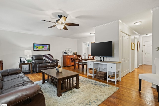 living room with ceiling fan, crown molding, and hardwood / wood-style floors