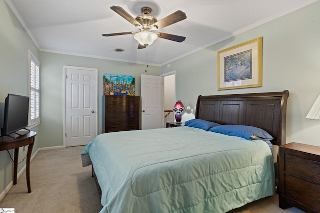 carpeted bedroom featuring ceiling fan and crown molding