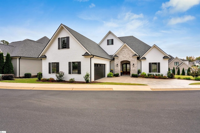 french provincial home with french doors and a garage