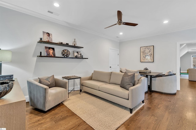 living room with crown molding, hardwood / wood-style floors, and ceiling fan