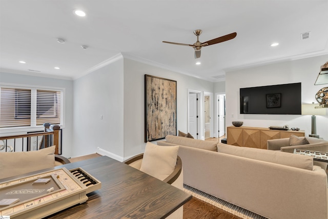 living room featuring hardwood / wood-style floors, ceiling fan, and ornamental molding