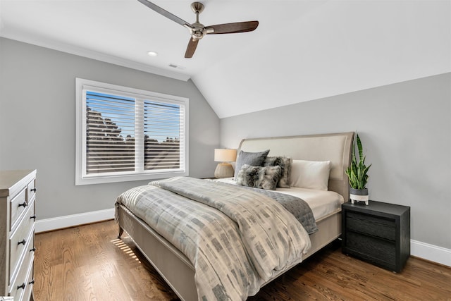 bedroom featuring ceiling fan, dark hardwood / wood-style flooring, and vaulted ceiling