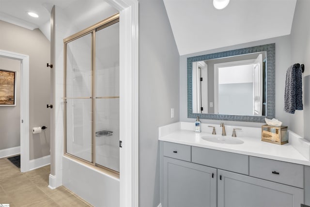 bathroom with tile patterned floors, vanity, vaulted ceiling, and enclosed tub / shower combo