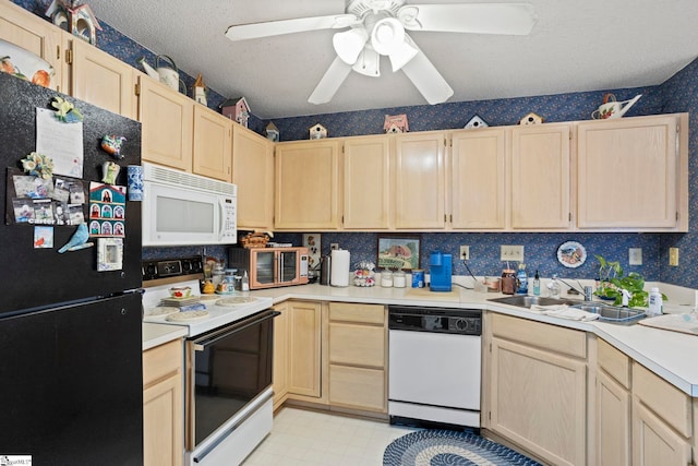 kitchen featuring light brown cabinets, white appliances, ceiling fan, and sink