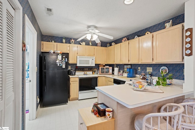 kitchen with a textured ceiling, kitchen peninsula, light brown cabinetry, and white appliances