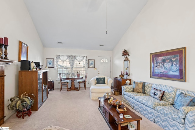 living room with light colored carpet and high vaulted ceiling