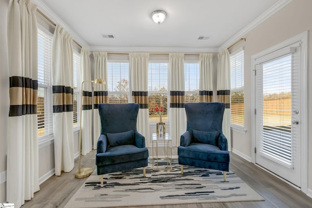 living area featuring crown molding and wood-type flooring