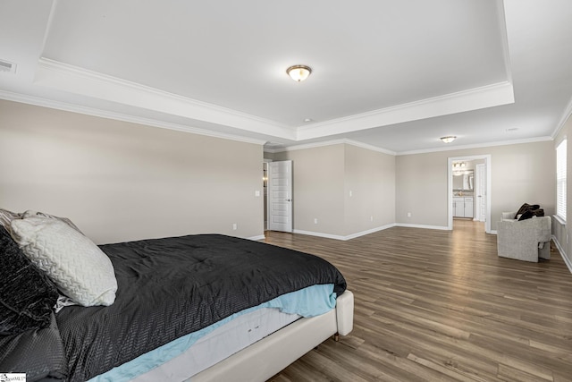 bedroom with a raised ceiling, hardwood / wood-style flooring, and ornamental molding