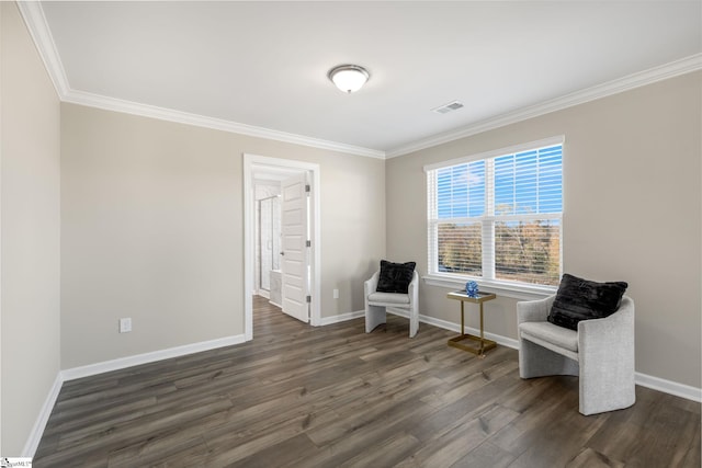 sitting room featuring ornamental molding and dark wood-type flooring