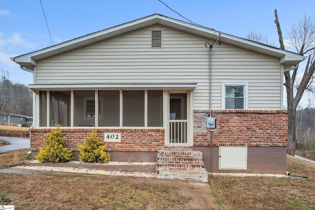 view of front of home featuring a sunroom