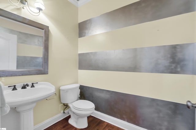 bathroom with sink, toilet, wood-type flooring, and ornamental molding