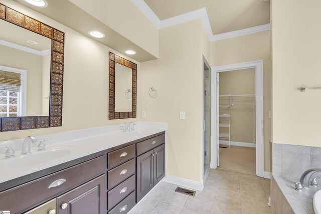 bathroom featuring vanity, tiled bath, tile patterned floors, and ornamental molding