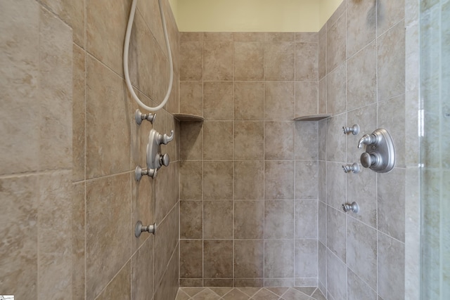 interior details featuring a tile shower