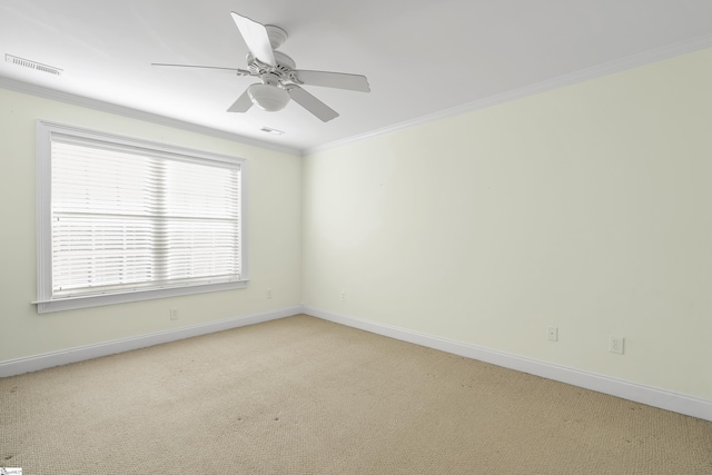 unfurnished room with plenty of natural light, ceiling fan, light colored carpet, and crown molding