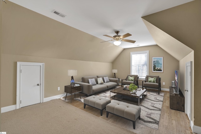 living room featuring ceiling fan, light hardwood / wood-style flooring, and lofted ceiling