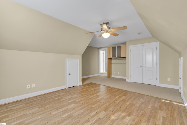 bonus room with ceiling fan, light hardwood / wood-style floors, and vaulted ceiling