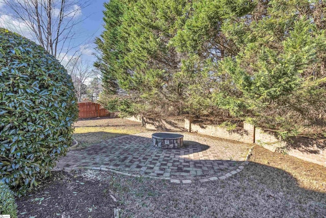 view of yard with an outdoor fire pit and a patio