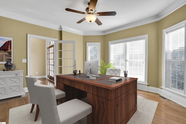 office space featuring ceiling fan, french doors, crown molding, and light hardwood / wood-style flooring