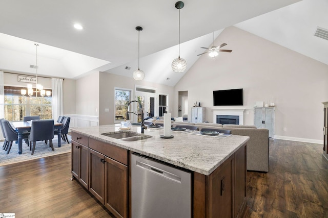 kitchen with dishwasher, sink, hanging light fixtures, a center island with sink, and ceiling fan with notable chandelier