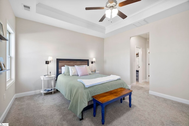 bedroom featuring carpet, ceiling fan, a raised ceiling, and crown molding