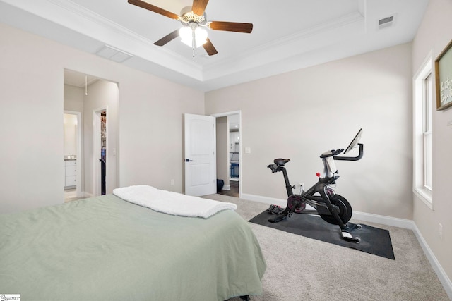 carpeted bedroom featuring a raised ceiling, ceiling fan, and ornamental molding